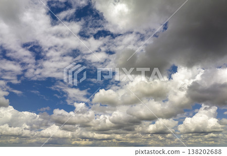 Blue sky with white summer rain clouds. Colorful summer landscape Blue sky with white summer rain clouds. Colorful summer landscape 138202688