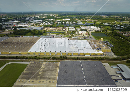 Big corporate shipment center with many cargo semi trucks unloading and uploading retail products for further retail shipment. Global market concept Big corporate shipment center with many cargo semi trucks unloading and uploading retail products for further retail shipment. Global market concept 138202709