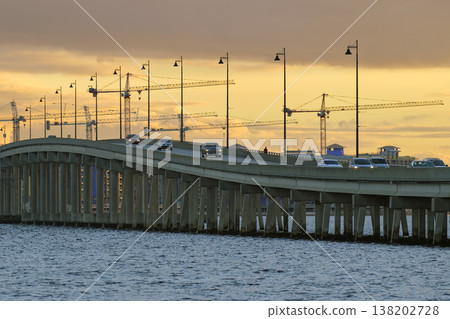 Barron Collier Bridge and Gilchrist Bridge in Florida with moving traffic. Transportation infrastructure in Charlotte County connecting Punta Gorda and Port Charlotte over Peace River Barron Collier Bridge and Gilchrist Bridge in Florida with moving traffic. Transportation infrastructure in Charlotte County connecting Punta Gorda and Port Charlotte over Peace River 138202728