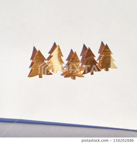 Golden Christmas Trees Cutouts On White Paper Casting Shadows Under Sunlight Golden Christmas Trees Cutouts On White Paper Casting Shadows Under Sunlight 138202886