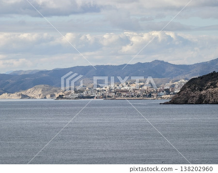 Tranquil coastal area under overcast sky, Peaceful harbor town with subdued colors and reflective atmosphere 138202960