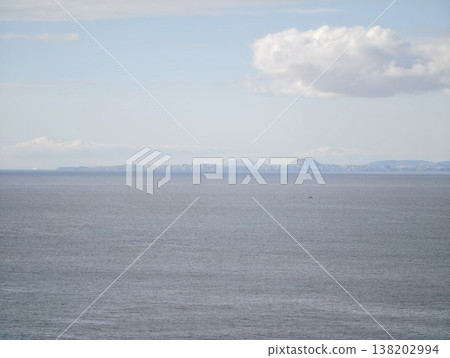 Relaxing open ocean landscape with single drifting cloud illuminated softly for meditative ambiance Relaxing open ocean landscape with single drifting cloud illuminated softly for meditative ambiance 138202994