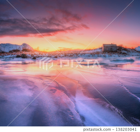 Frozen sea coast and house at colorful sunset. Winter landscape Frozen sea coast and house at colorful sunset. Winter landscape 138203041