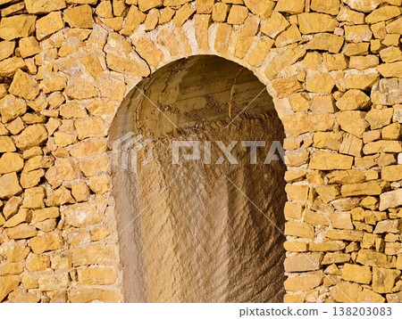 Heritage architectural marvel featuring sunlit sandstone arch and intricate craftsmanship details 138203083