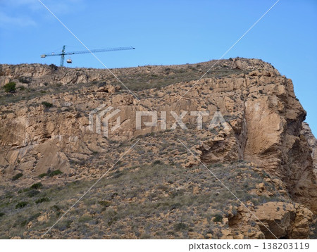 Trail by cliffs, Journey along craggy ridge with coastal scenery and stone steps during golden light Trail by cliffs, Journey along craggy ridge with coastal scenery and stone steps during golden light 138203119