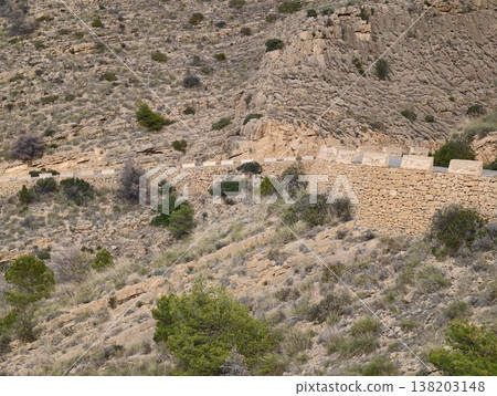 Heritage walkway crossing sunlit hillside terrain, Dry scrub and sparse pine trees border hillside path Heritage walkway crossing sunlit hillside terrain, Dry scrub and sparse pine trees border hillside path 138203148
