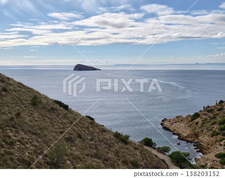 Breathtaking island view with hills, Serene seaside retreat featuring rocky outcrop and lush slopes Breathtaking island view with hills, Serene seaside retreat featuring rocky outcrop and lush slopes 138203152