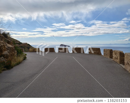 Secluded seaside highway, Remote shoreline route ending at rocky safety barriers with expansive ocean scenery 138203153