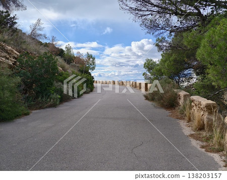 Tranquil coastal path offering unobstructed vistas and serene environment for outdoor exploration Tranquil coastal path offering unobstructed vistas and serene environment for outdoor exploration 138203157