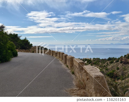 Open water panorama beyond stone railing offers tranquil setting for creative exploration and inner peace 138203163