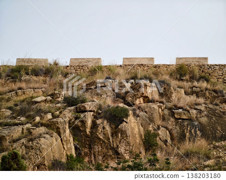 Rugged cliff face adorned with construction blocks ideal for geological investigation and field exploration Rugged cliff face adorned with construction blocks ideal for geological investigation and field exploration 138203180