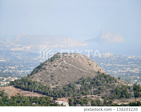 Quiet hill with city view, Conical summit overlooking peaceful landscape and urban scenery Quiet hill with city view, Conical summit overlooking peaceful landscape and urban scenery 138203220