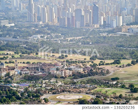 Residential areas in suburbs featuring extended view of distant urban skyline and active building sites Residential areas in suburbs featuring extended view of distant urban skyline and active building sites 138203236