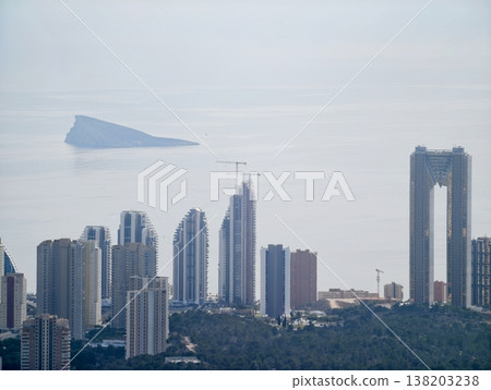 Mysterious aerial form hovers above bustling metropolis as skyscrapers and ships bustle below 138203238