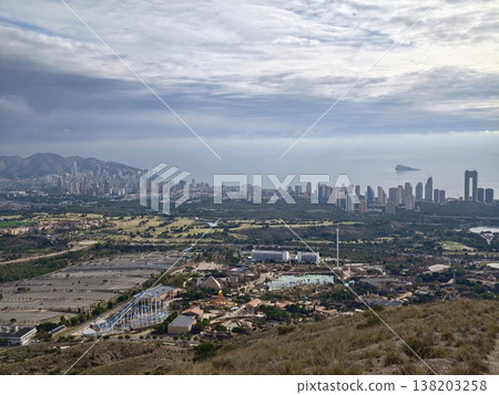 Ridge overlooking coastlines and clouds, Cityscape and shoreline under cloudy layers seen from hill Ridge overlooking coastlines and clouds, Cityscape and shoreline under cloudy layers seen from hill 138203258
