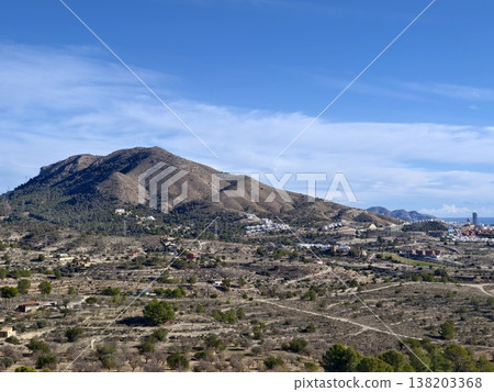 Hilly countryside with village views, Rustic landscape featuring hills villages and rocky patches 138203368