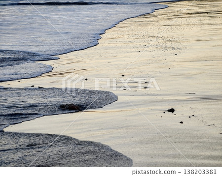 Calm ocean waves with subtle foam, Serene beach environment featuring soft ripples and tranquil ambiance 138203381