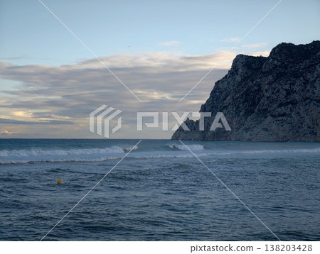 Churning ocean meets perilous rocky coastline, Unsettled weather with crashing waves against rugged cliffs Churning ocean meets perilous rocky coastline, Unsettled weather with crashing waves against rugged cliffs 138203428