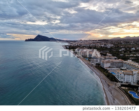 Bright sunset over calm waters, Spectacular twilight with fiery horizon and tranquil shoreline view Bright sunset over calm waters, Spectacular twilight with fiery horizon and tranquil shoreline view 138203477