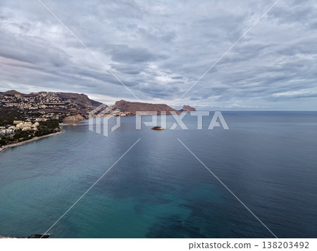 Mysterious seascape under gloomy cloud cover, Quiet horizon over open waters with muted colors and islands 138203492