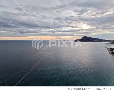 Peaceful sunset over harbor, Calm shoreline during sunset featuring silhouette and gentle waves 138203495