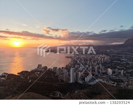 Cloudy coast with bright sunlight over ocean, Dramatic sky above textured coast with shining sunlight 138203524