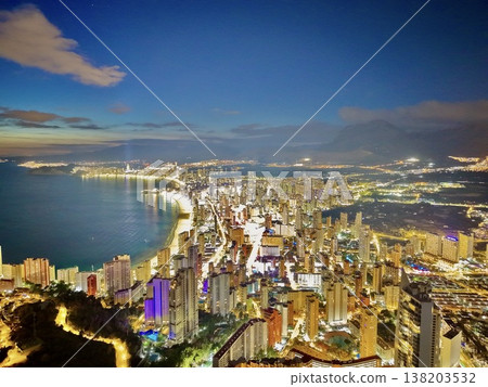 Evening illumination reveals flourishing skyscrapers and resorts enticing investor interest 138203532