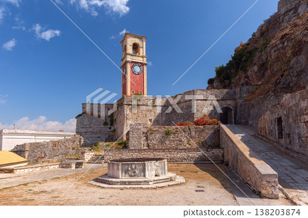 Clock tower and stone walls of Old Fortress in Corfu Town, Greece 138203874