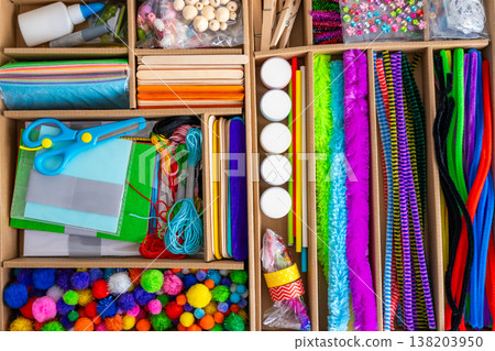 Organized craft kit with scissors paper glue beads and colorful materials in storage box. Kids education creativity and hands on learning concept. Organized craft kit with scissors paper glue beads and colorful materials in storage box. Kids education creativity and hands on learning concept. 138203950