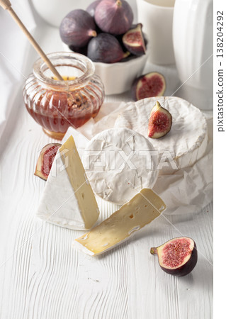 Brie cheese with figs and honey. 138204292