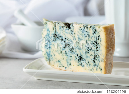 Gorgonzola cheese on a white table. Gorgonzola cheese on a white table. 138204296