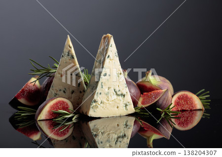 Blue cheese with fresh figs and rosemary on a black background. Blue cheese with fresh figs and rosemary on a black background. 138204307