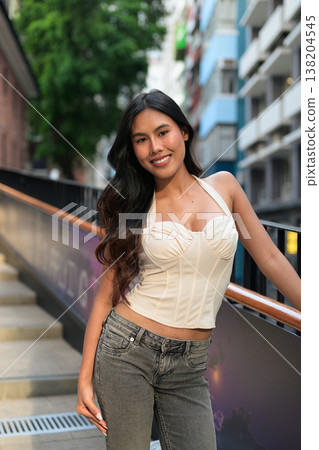 Asian Woman Smiling on Outdoor Stairs in Hong Kong Asian Woman Smiling on Outdoor Stairs in Hong Kong 138204545