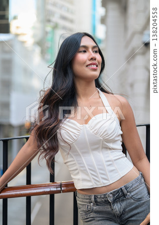 Asian Woman Smiling on Balcony in Central Hong Kong Asian Woman Smiling on Balcony in Central Hong Kong 138204558