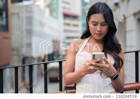 Asian Woman Using Smartphone in Central Hong Kong 138204559