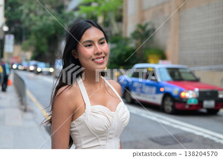 Young Asian Woman Smiling on Street with Hong Kong Taxi Background 138204570