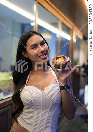 Thai Woman Holding Egg Tart on Hong Kong Street Thai Woman Holding Egg Tart on Hong Kong Street 138204589