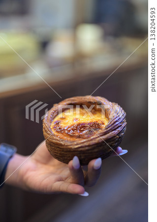Egg Tart Held by Hand in Hong Kong 138204593