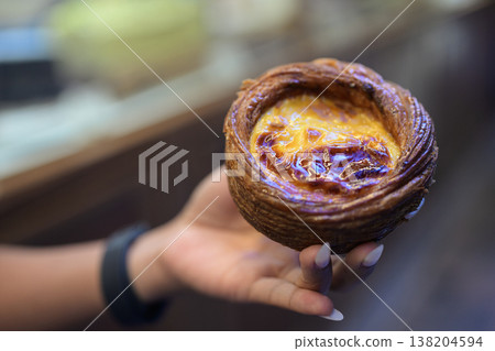 Egg Tart Held by Hand in Hong Kong Egg Tart Held by Hand in Hong Kong 138204594