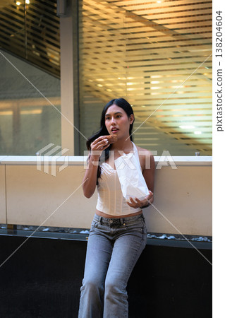 Thai Woman Holding Egg Tart on Hong Kong Street Thai Woman Holding Egg Tart on Hong Kong Street 138204604