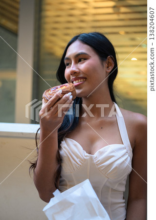 Thai Woman Holding Egg Tart on Hong Kong Street Thai Woman Holding Egg Tart on Hong Kong Street 138204607