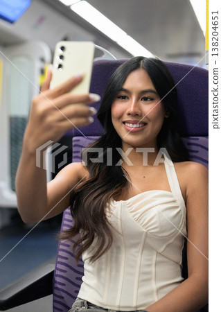 Asian Woman Taking Selfie on Hong Kong Train 138204651