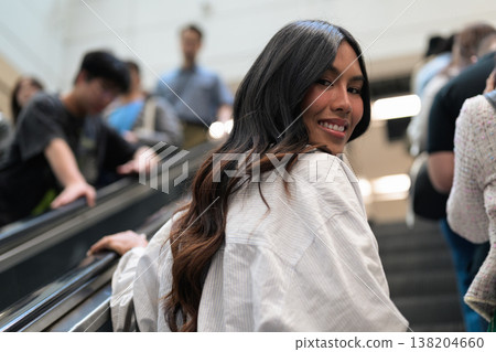 Asian Woman Smiling on Escalator in Hong Kong 138204660