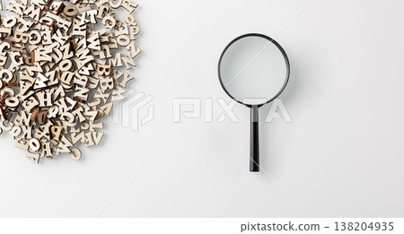 wooden letters english alphabet with lens on white background 138204935