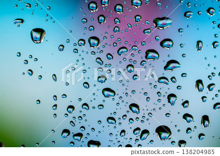 Beautiful multi-colored water droplets on a glass 138204985