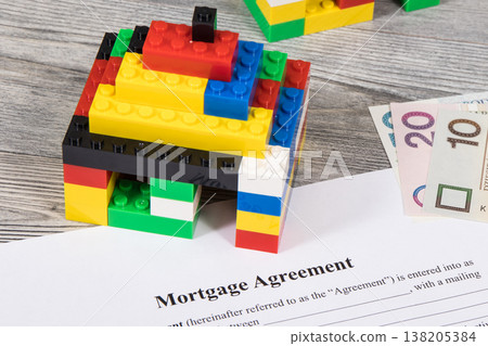 House made of toy blocks, mortgage agreement form and polish currency money House made of toy blocks, mortgage agreement form and polish currency money 138205384