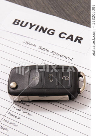 Car key, inscription buying car and vehicle sales agreement. Sales or purchases new or used vehicle Car key, inscription buying car and vehicle sales agreement. Sales or purchases new or used vehicle 138205395