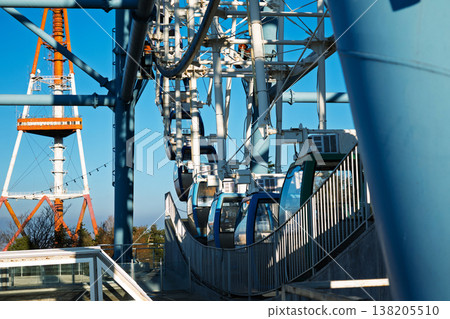 Modern Ferris wheel cabins paired with the iconic Tbilisi TV Tower under a clear blue Georgian sky 138205510