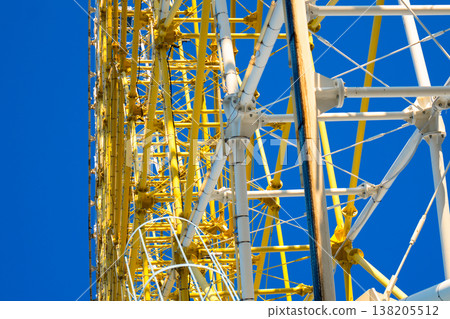Close-up of white and yellow structural steel truss joints on a modern amusement park ride 138205512