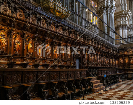 Ornate Wooden Choir Stalls in Historic Malaga Cathedral Interior With Carved Saints and Stone Columns Ornate Wooden Choir Stalls in Historic Malaga Cathedral Interior With Carved Saints and Stone Columns 138206229